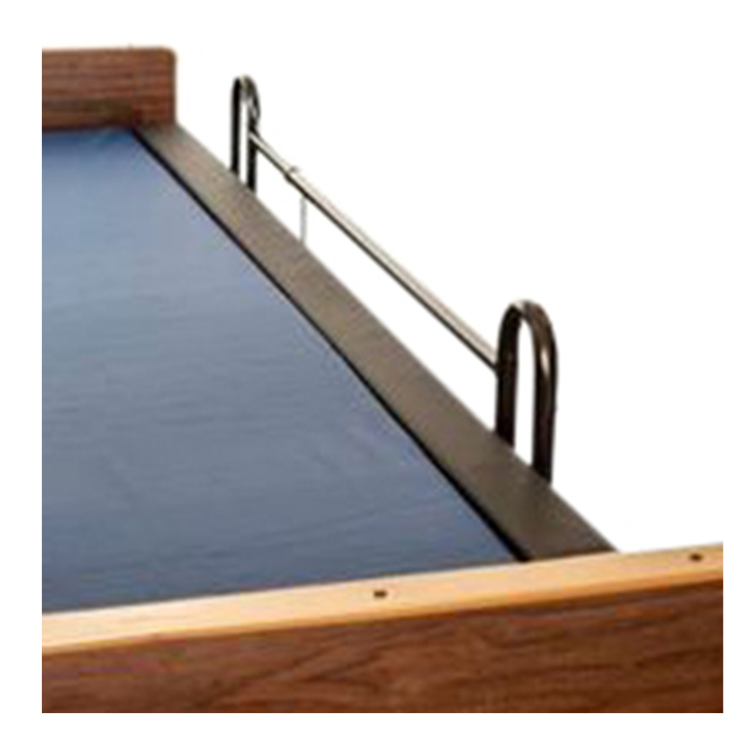 A close-up view of a bed with a dark blue mattress, wooden headboard and footboard, a metal safety rail, and the Proactive Protekt® Rail Guard - Bedside Gap Filler for enhanced entrapment protection and improved bed safety.